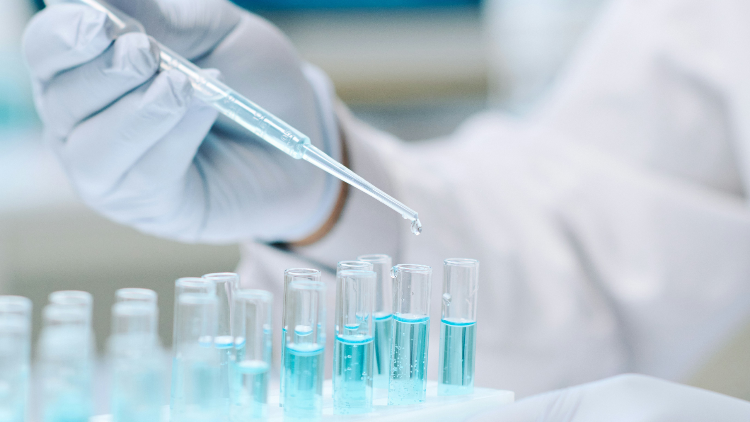 Scientist handling pipette over test tubes in a biotech lab, symbolising technical expertise sought by hiring managers