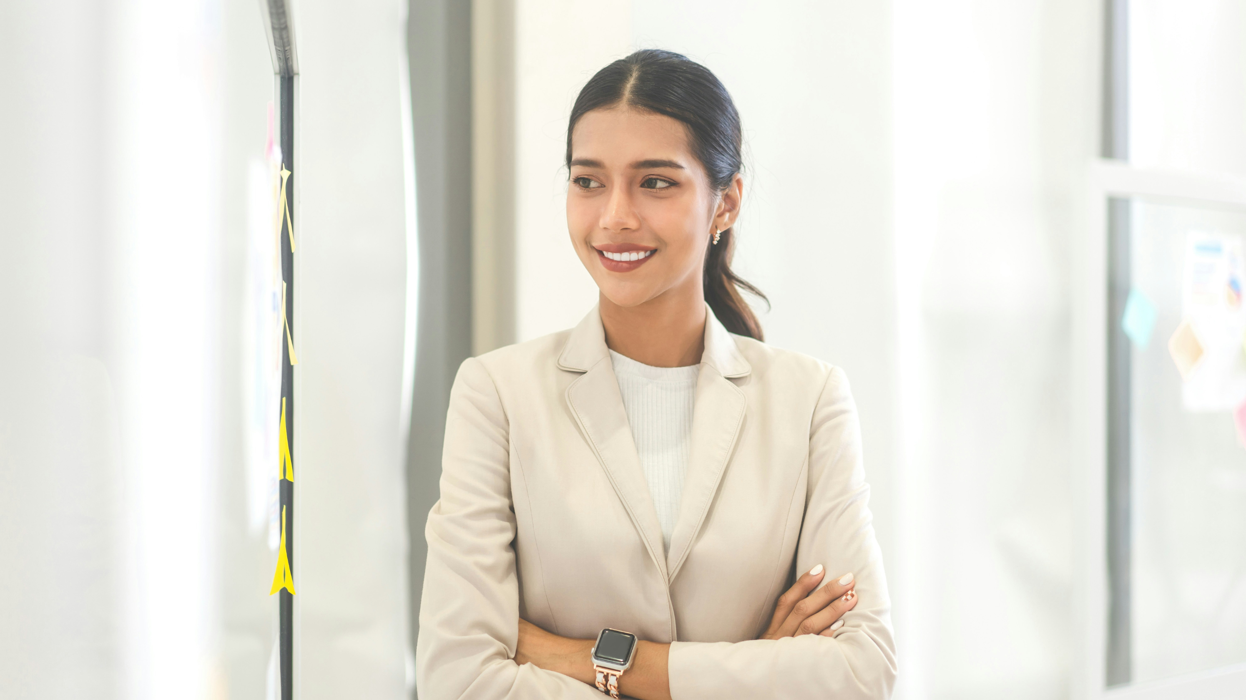 A confident life sciences professional stands in a bright, modern office. The image reflects Axion’s focus on building trust through strategic, compliant hiring processes that empower high-impact leaders in regulated environments.